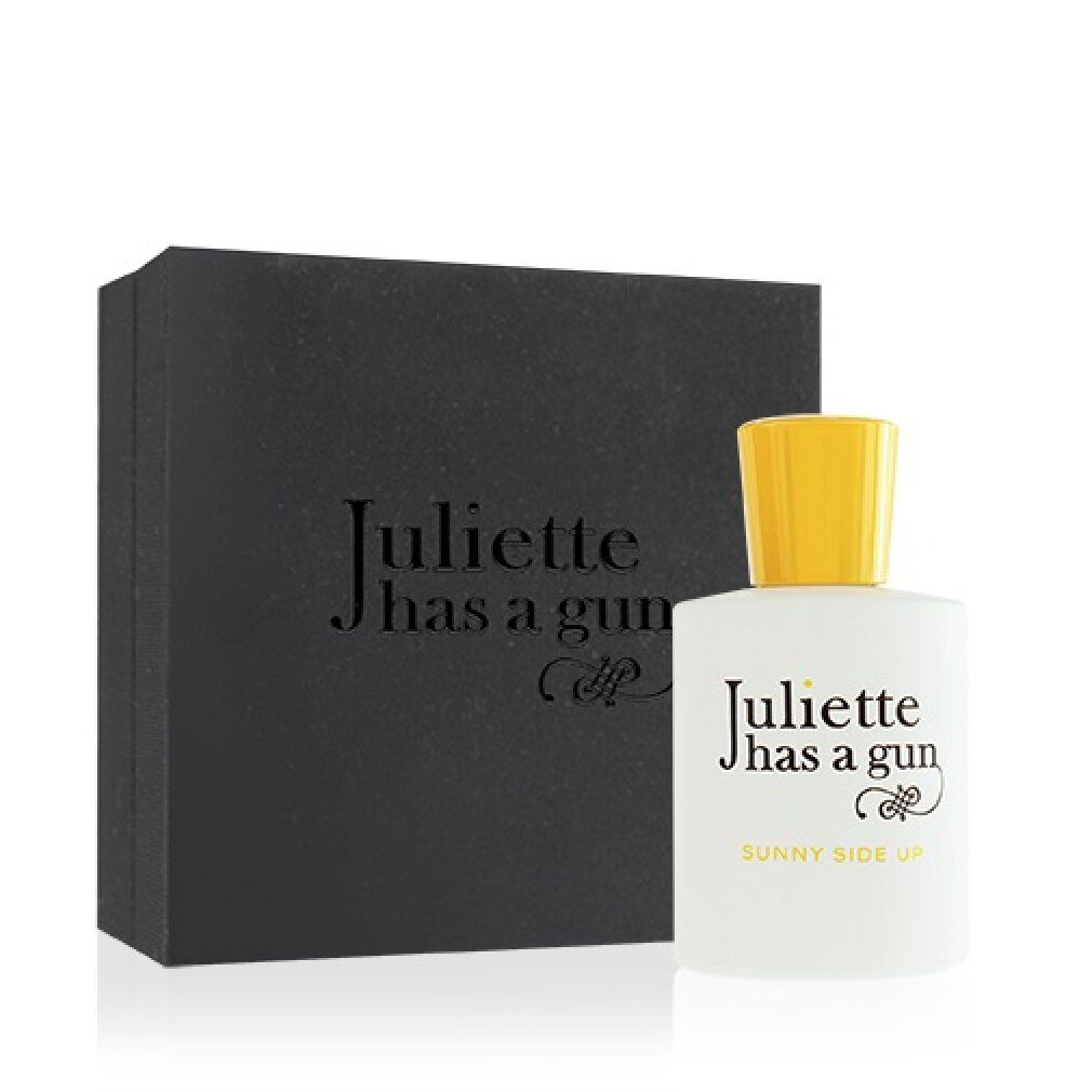 Boîte noire et flacon blanc à bouchon jaune. Texte noir: Juliette has a gun, Sunny Side Up.