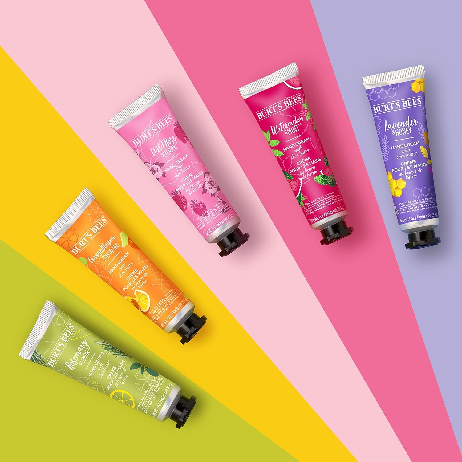 Vijf handcrèmetubes in verschillende kleuren. Productnaam: Burt's Bees. Verschillende geuren.