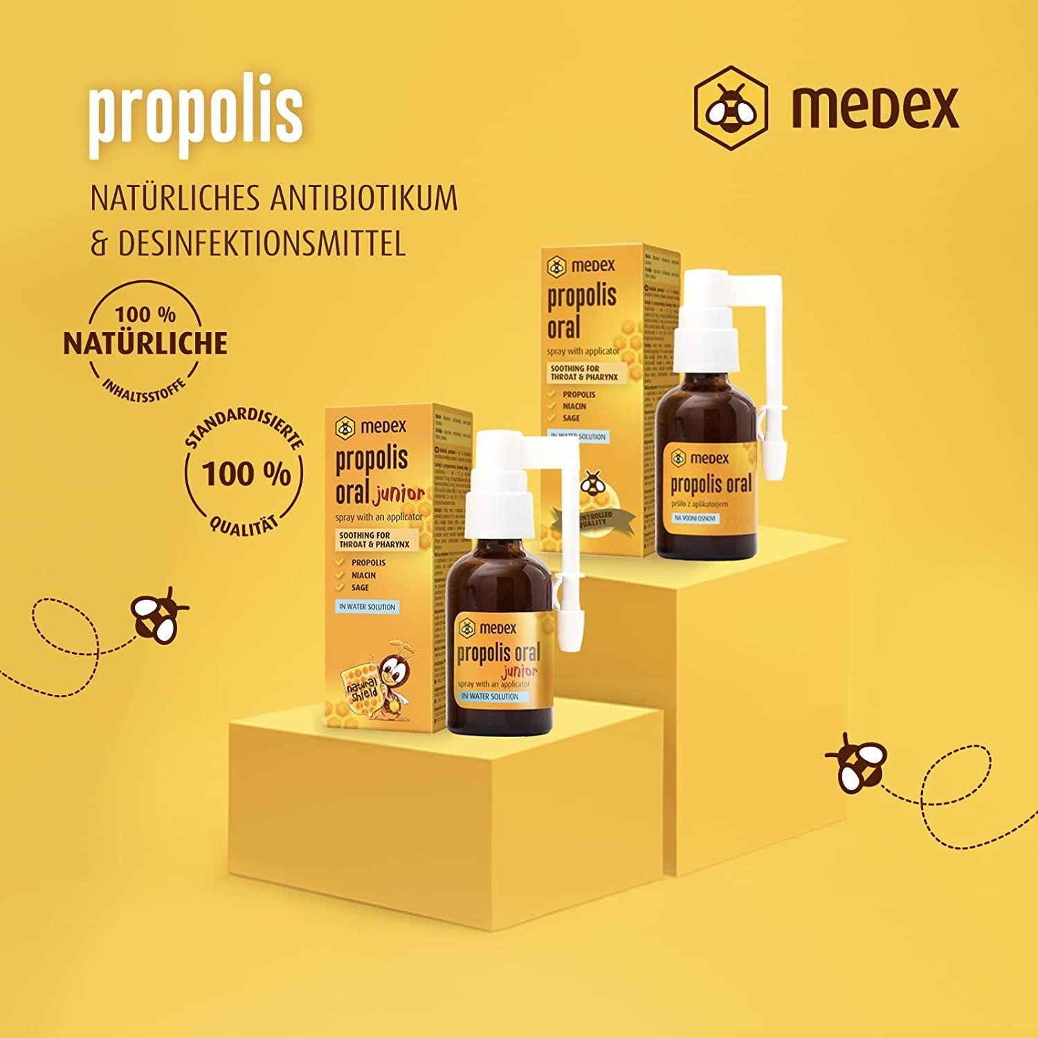 Medex Propolis Oral en Junior sprayflessen en dozen op sokkels.
