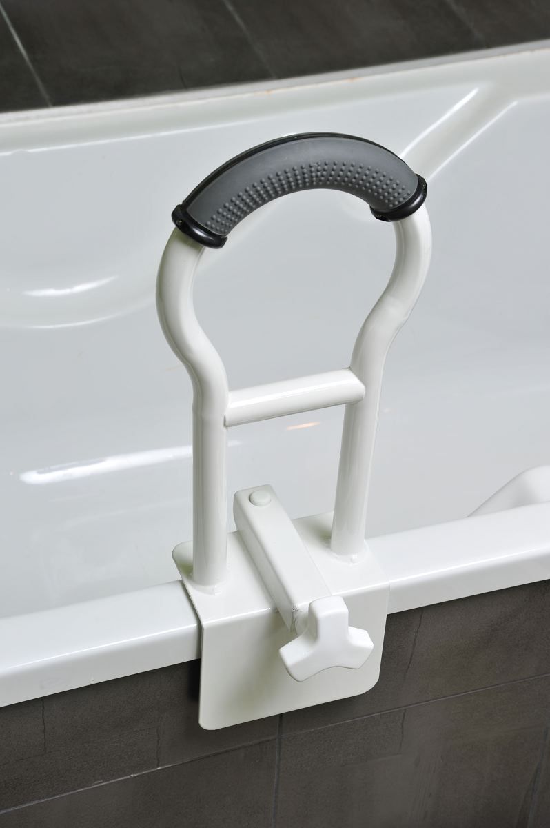 Barre d'appui blanche sur le bord d'une baignoire. Poignée grise antidérapante. Dispositif de serrage.