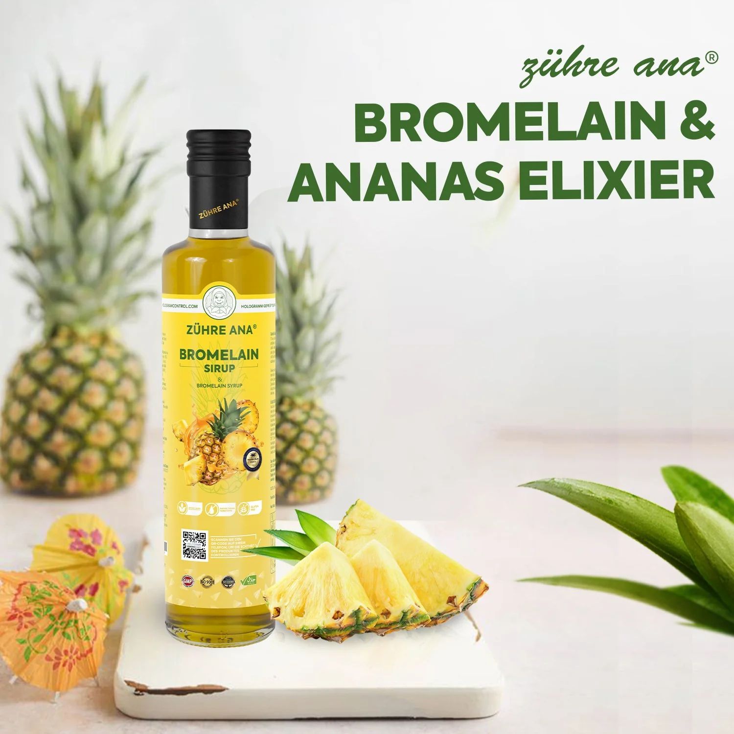 Bouteille jaune avec bouchon noir. Inscription: Zühre Ana Bromelain Sirop. Ananas et morceaux d'ananas à côté.