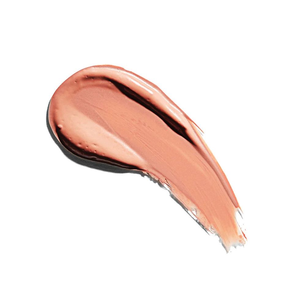 Un échantillon crémeux de rouge à lèvres rose sur fond blanc. La texture est brillante.