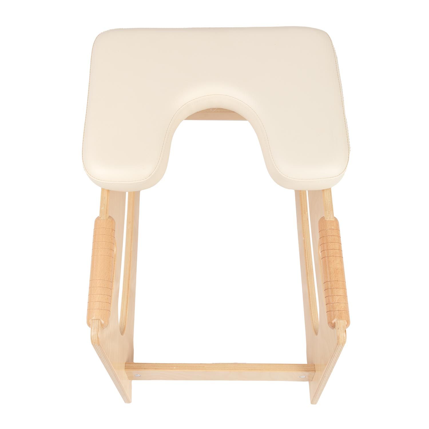 Tabouret de tête, vue de dessus. Cadre en bois avec coussin crème. Poignées latérales. Ouvertures rondes dans le cadre en bois.