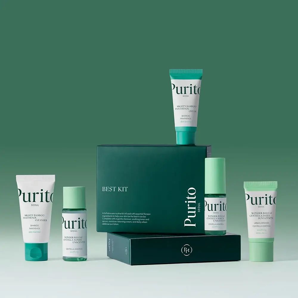 Plusieurs produits de soin pour la peau en format voyage. Tubes et flacons verts et blancs, disposés devant une boîte verte avec "BEST KIT".