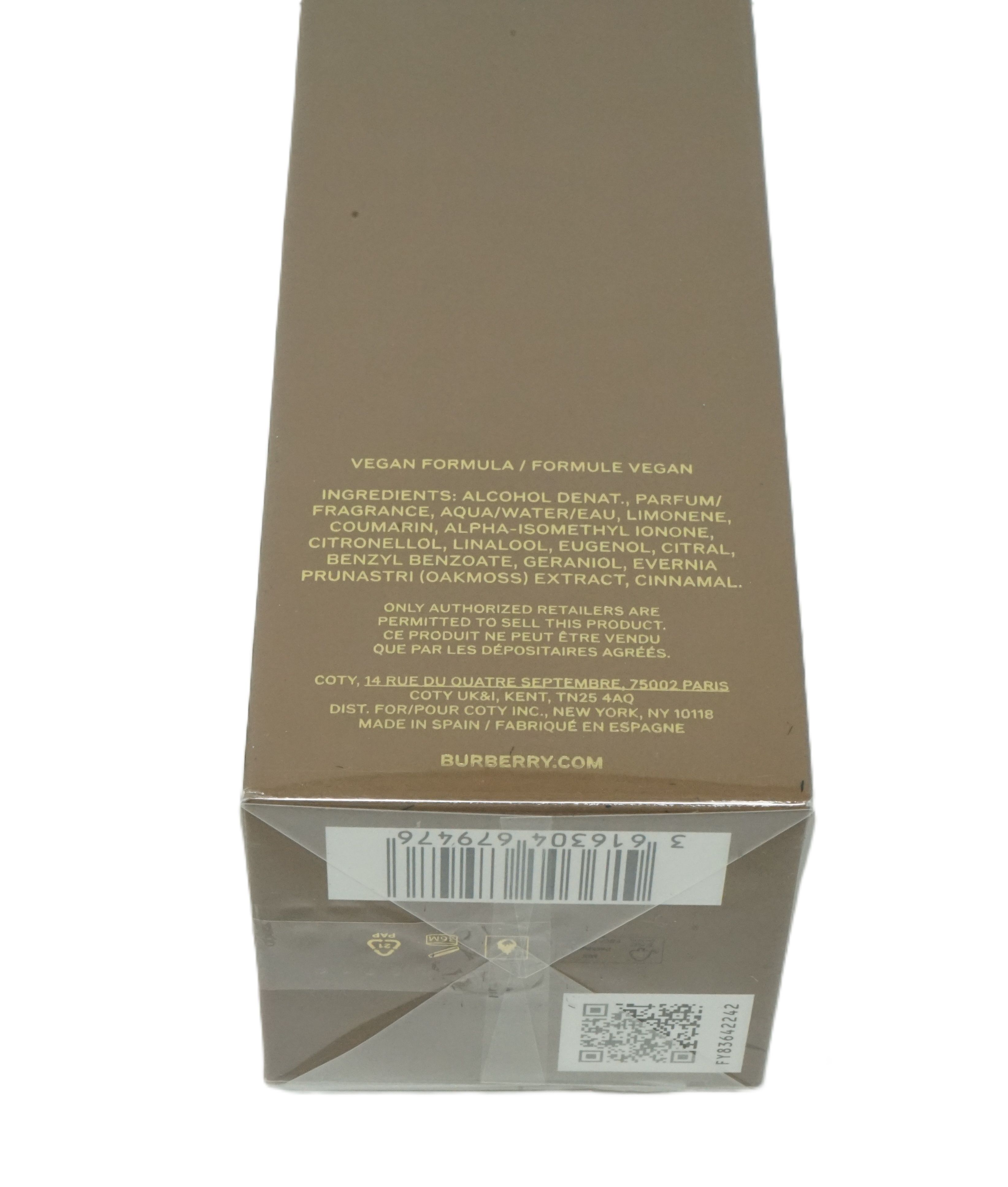 Bruine rechthoekige verpakking met tekst. Ingrediëntenlijst, fabrikantinfo en barcode.