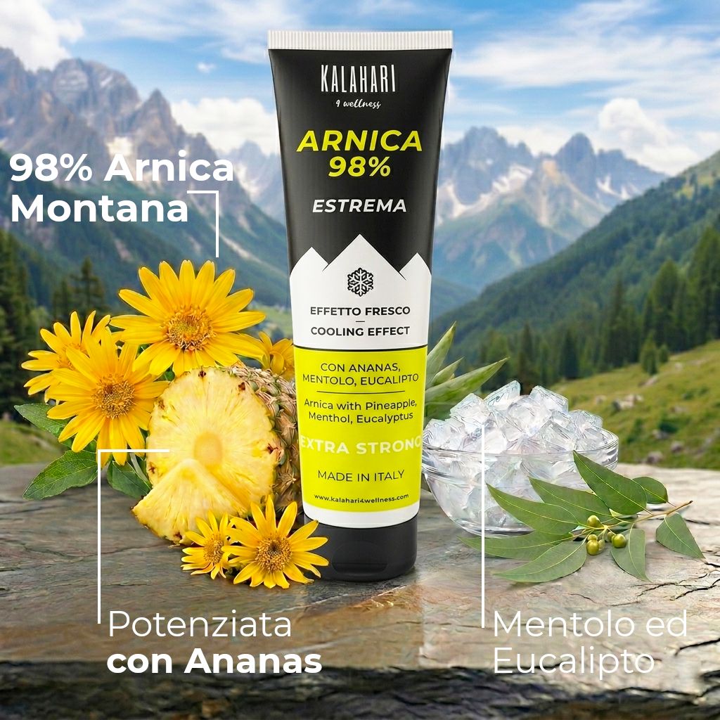 Tube "Arnica 98% Estrema" devant un paysage de montagne avec arnica, ananas, menthe et eucalyptus.