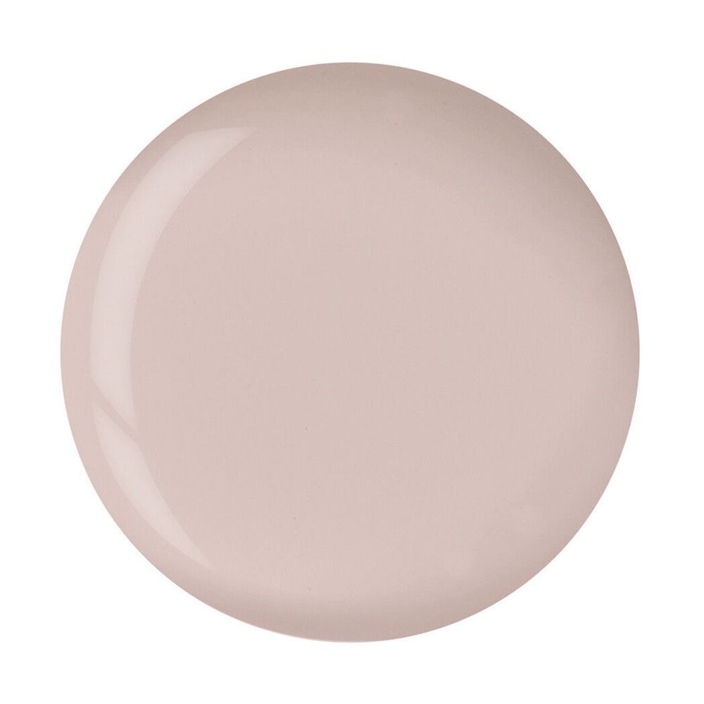 Tache ronde et brillante, rose clair. Fond blanc.