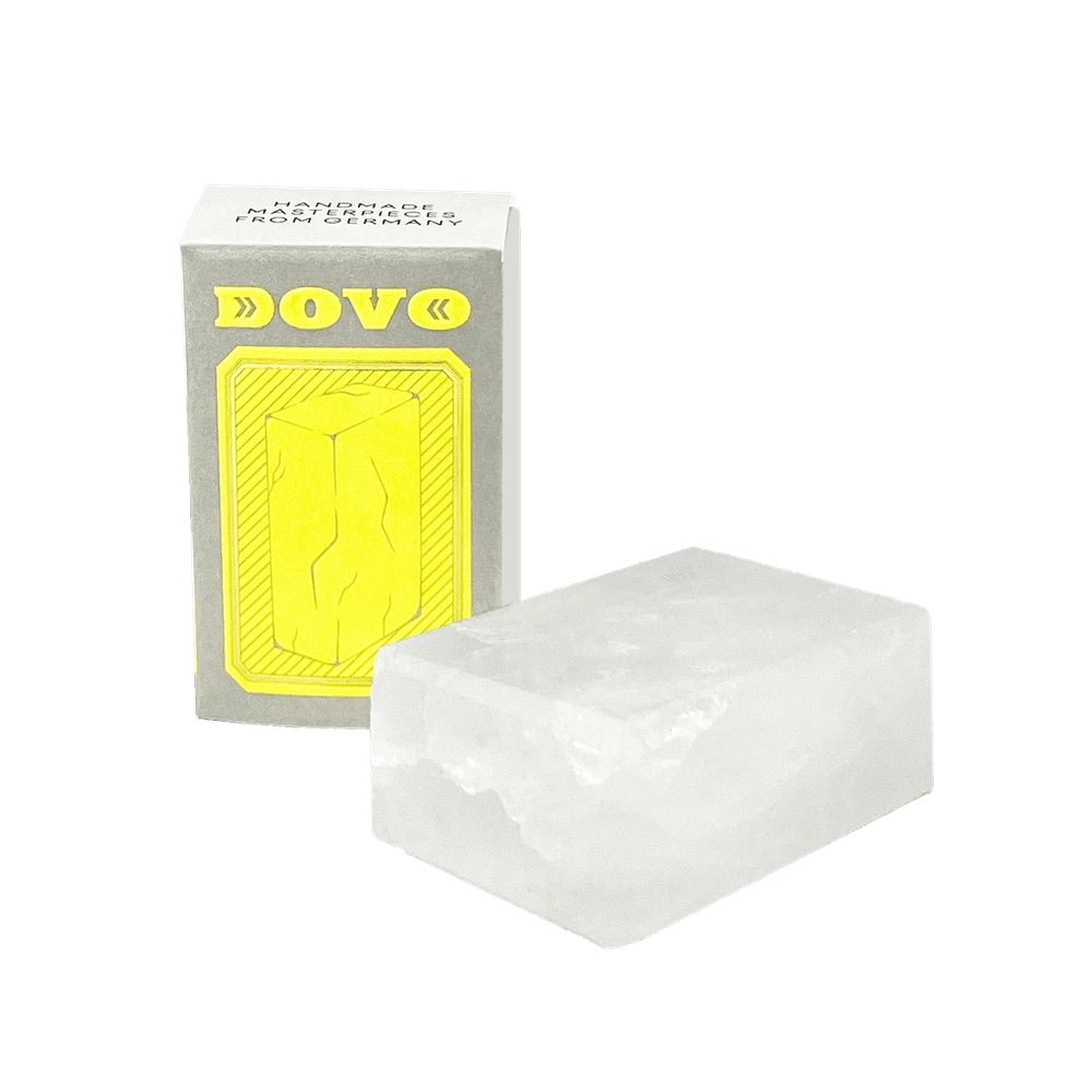 Rechthoekige aluinsteen naast grijze doos met gele productafbeelding en DOVO-logo.