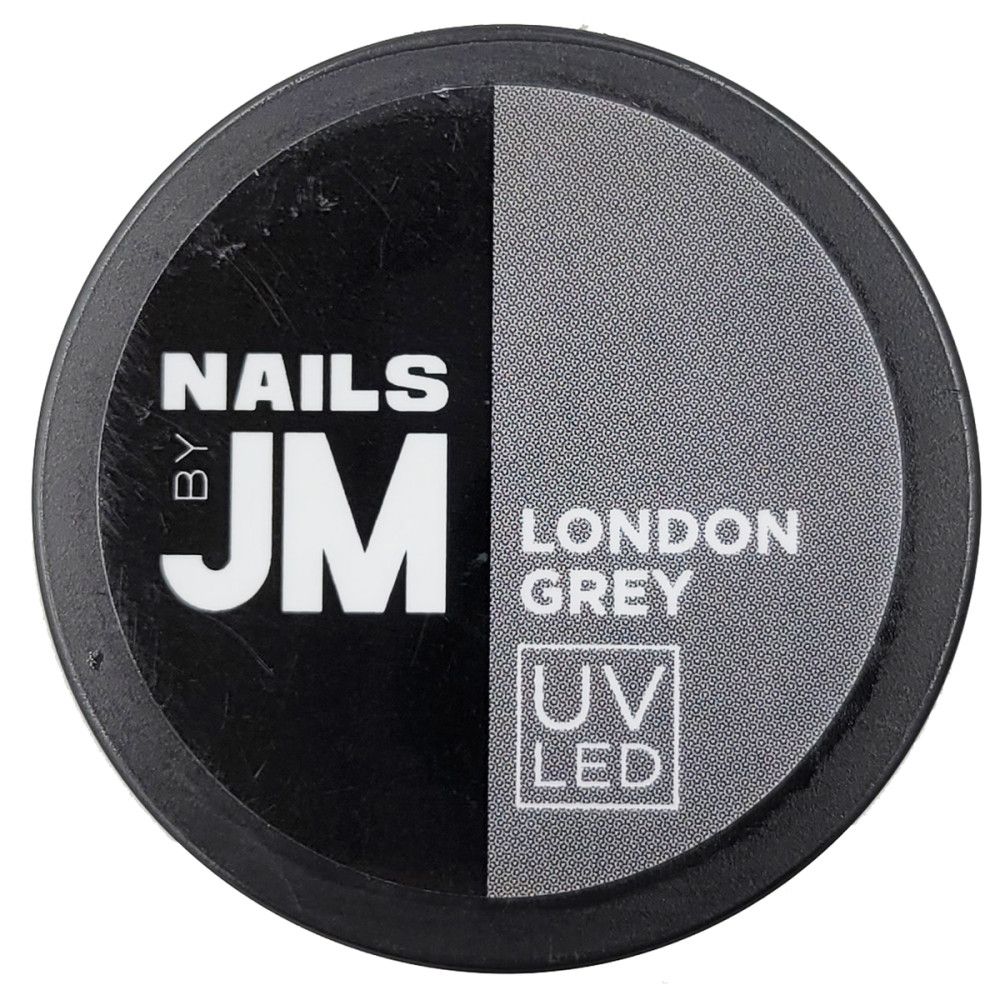 Contenant rond noir et gris. Inscription "NAILS BY JM", dessous "LONDON GREY" et "UV LED".