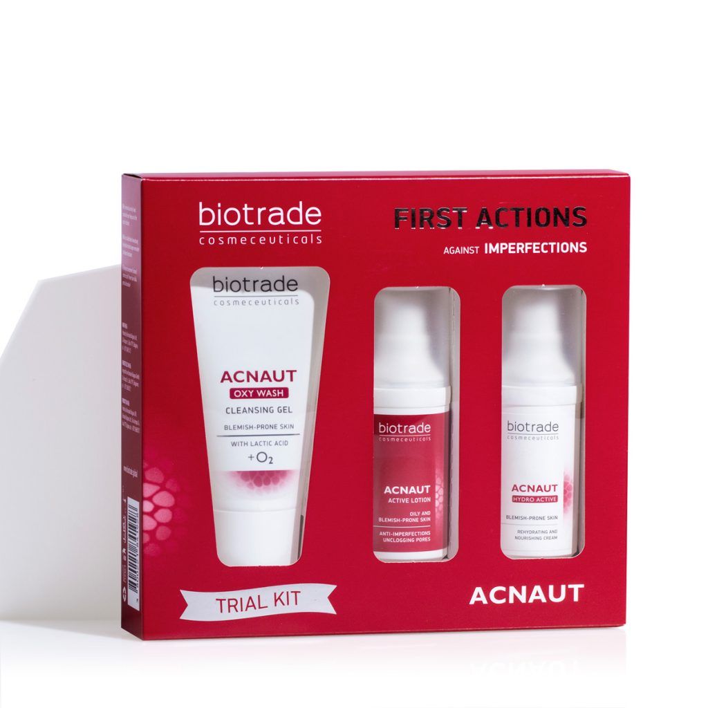 Rode Biotrade Acnaut verpakking met reinigingsgel, lotion en crème. Bevat "FIRST ACTIONS" tegen onzuiverheden.