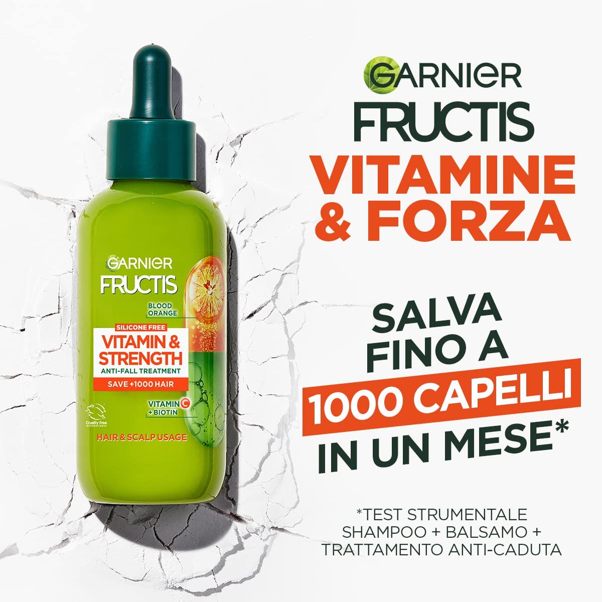 Groene fles met druppelaar. Opschrift: Garnier Fructis Vitamine & Kracht. Anti-haaruitval behandeling. Bevat Vitamine C & Biotine.