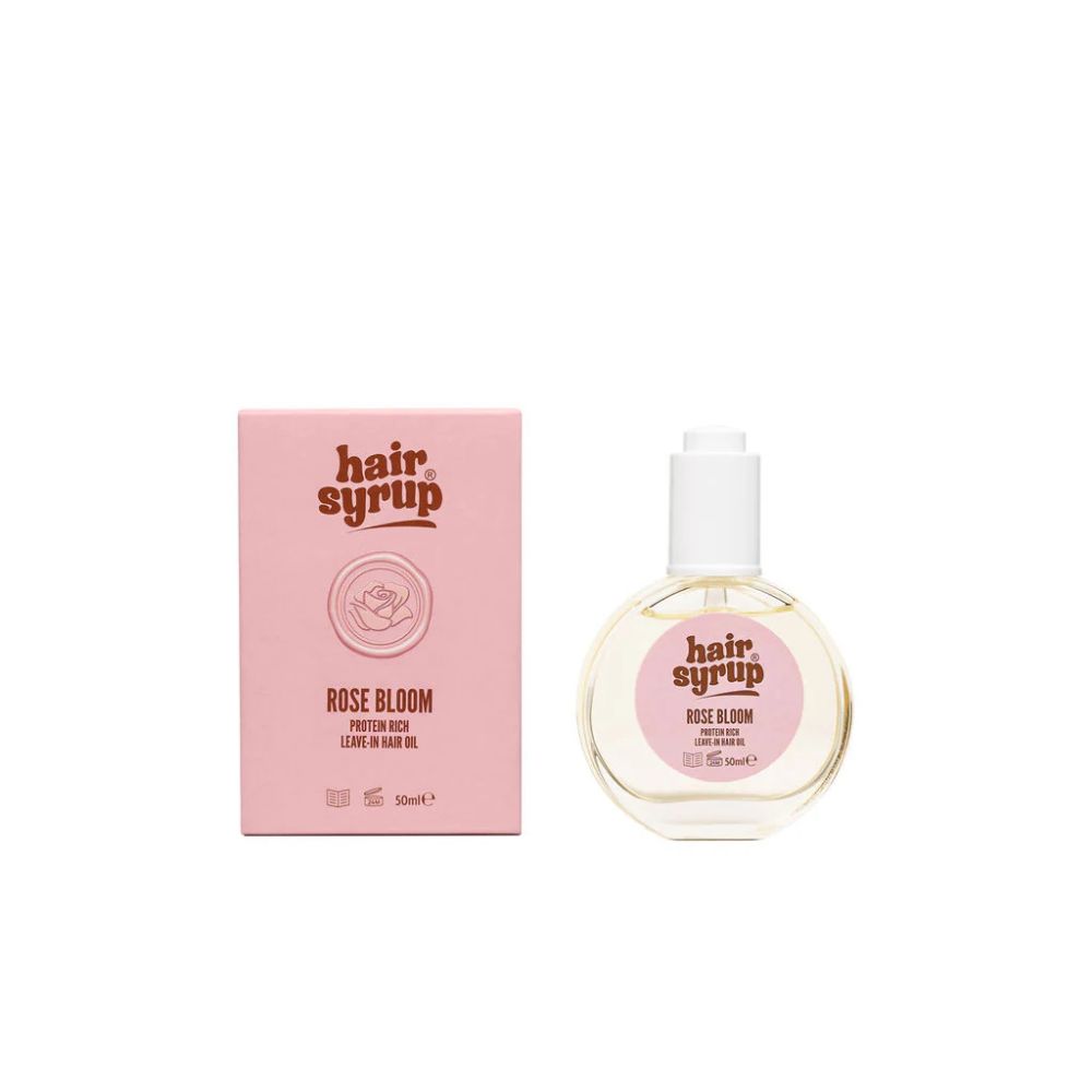 Hair Syrup Rose Bloom leave-in haarolie in ronde fles met druppelaar en roze doos.