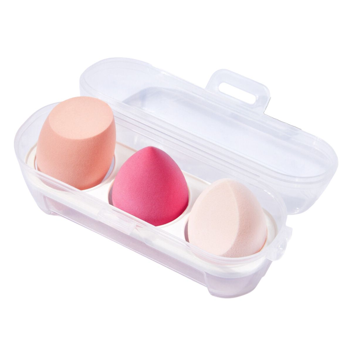 Drie perzikkleurige make-up sponsjes in een doorzichtig reisetui.