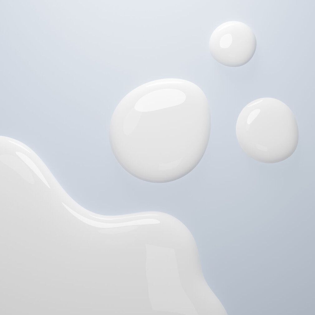Trois gouttes blanches et une vague de liquide blanc sur fond bleu clair.