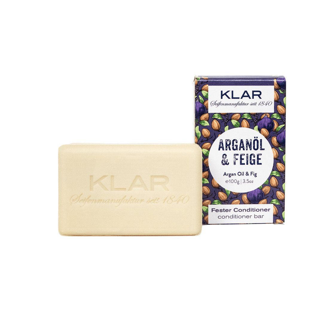 Klar-Seifen conditioner bar en verpakking. Lichte bar, paarse verpakking met Argan & Vijg.