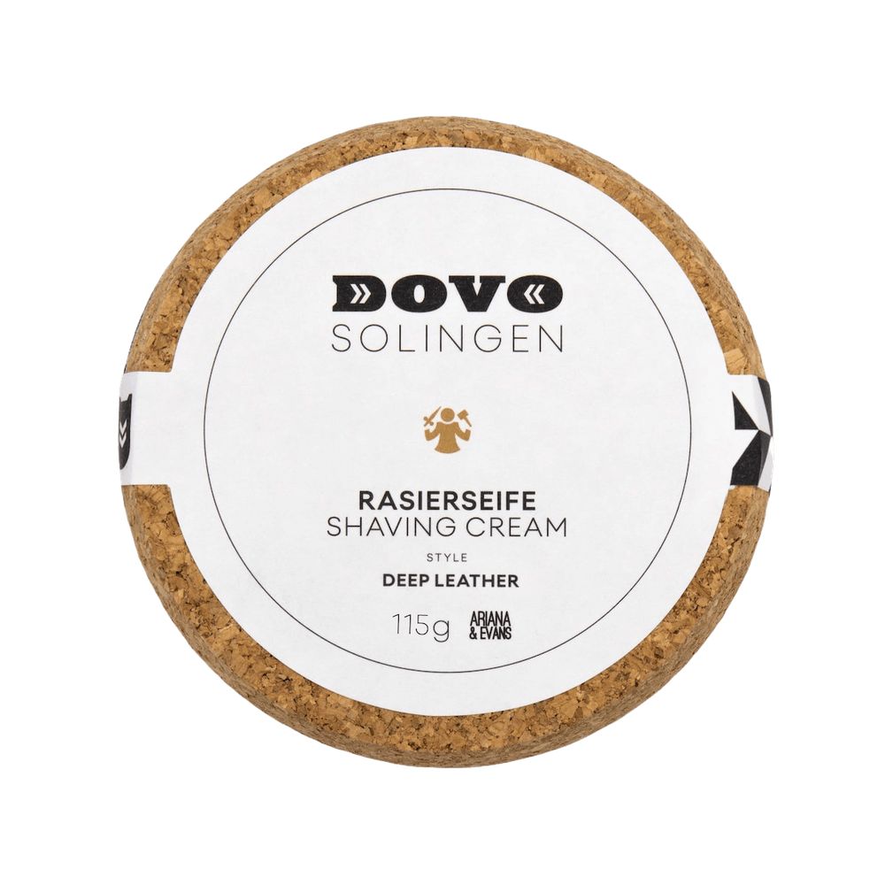 Boîte ronde avec couvercle en liège. Étiquette blanche avec logo DOVO, texte et symbole. Savon à raser.