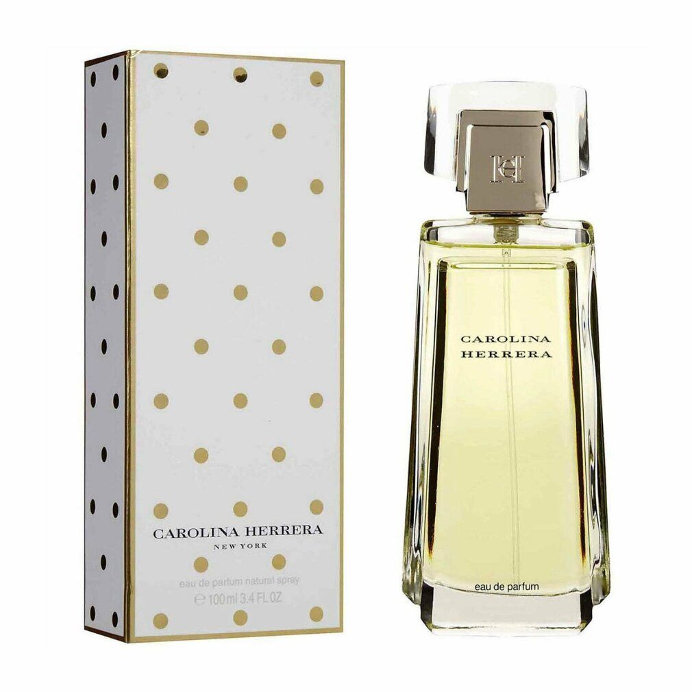 Parfumfles en verpakking. Fles rechthoekig, transparant. Verpakking wit met gouden stippen. Opschrift: CAROLINA HERRERA.