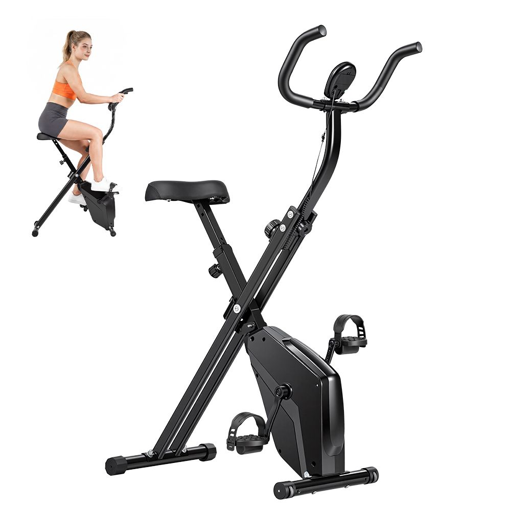 Vélo d'appartement pliable noir. Femme dessus. Selle, guidon, pédales et écran. Cadre métallique.