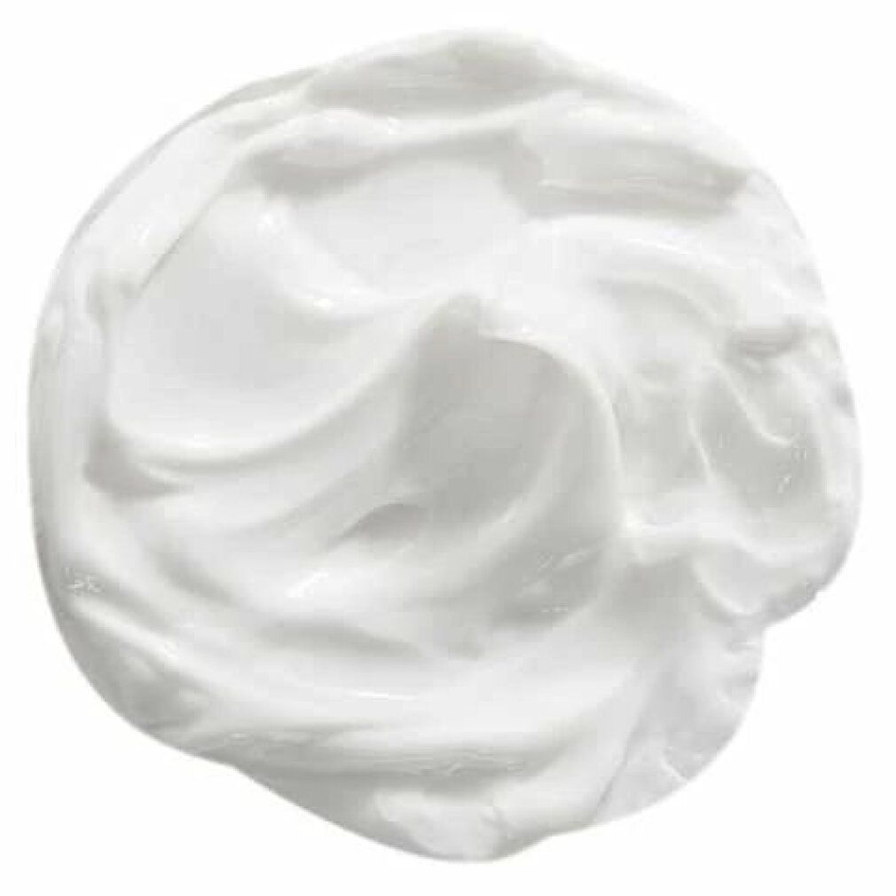 Close-up van een witte crème. De crème heeft een golvende textuur.