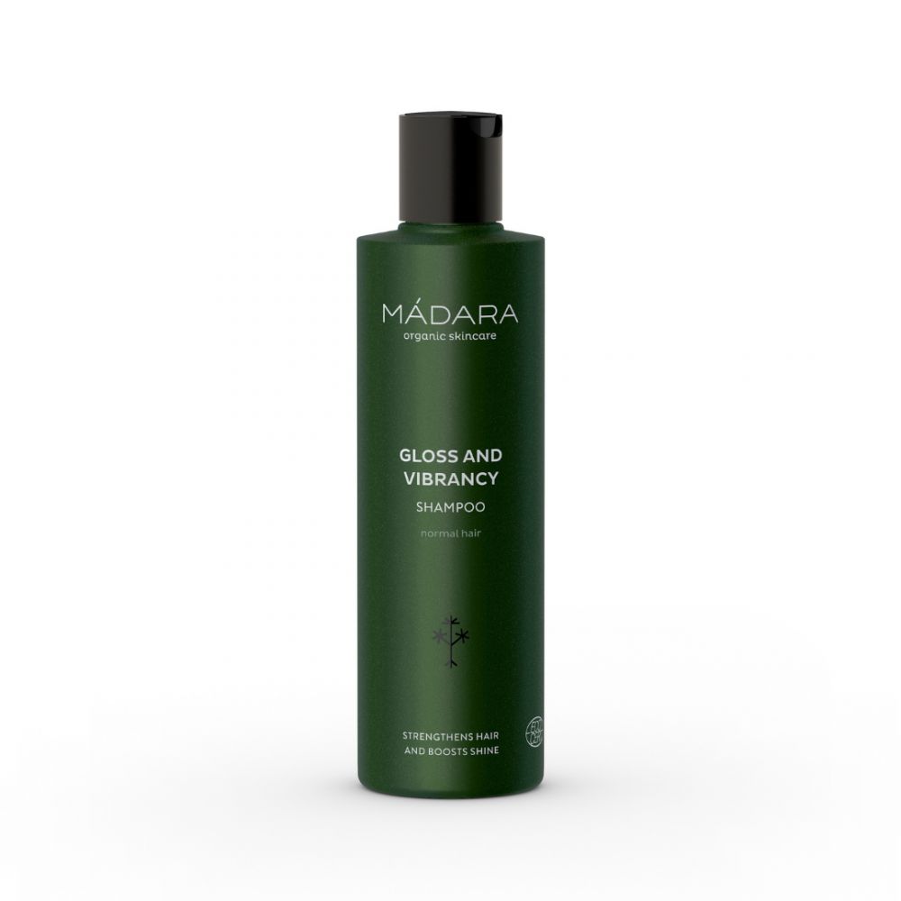 Flacon vert avec bouchon noir. Inscription: MÁDARA organic skincare, Gloss and Vibrancy Shampoo, renforce les cheveux et apporte de la brillance.
