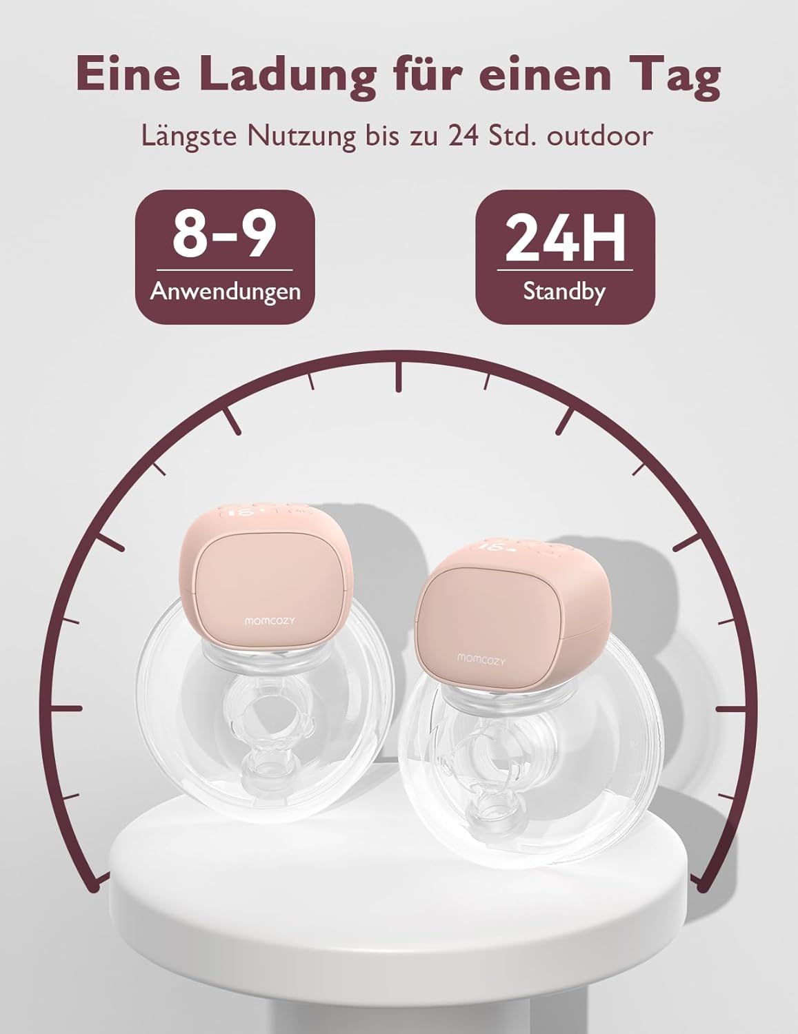 Deux tire-laits Momcozy roses sur un piédestal blanc, entourés d'une horloge stylisée.