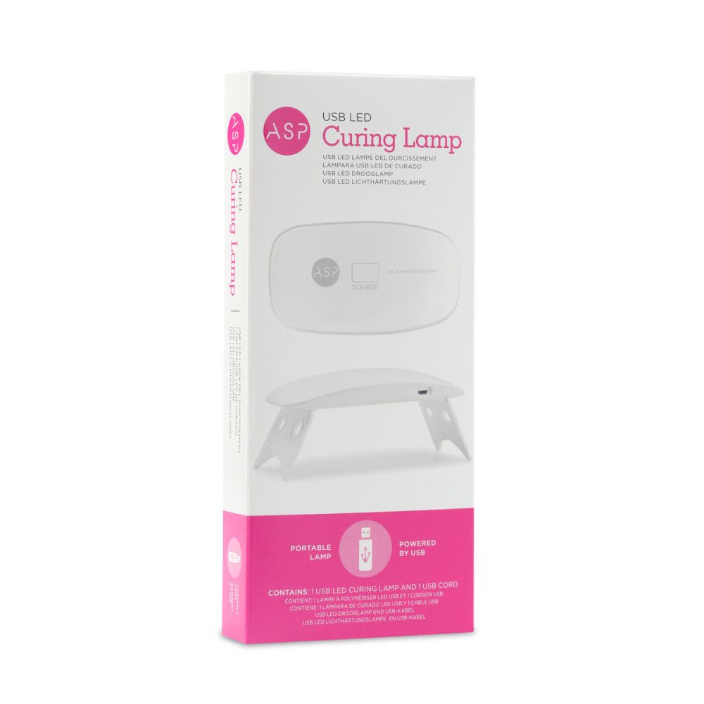 Emballage de la lampe ASP USB LED Curing. Blanc avec des accents roses. Image du produit et texte: USB LED Curing Lamp.