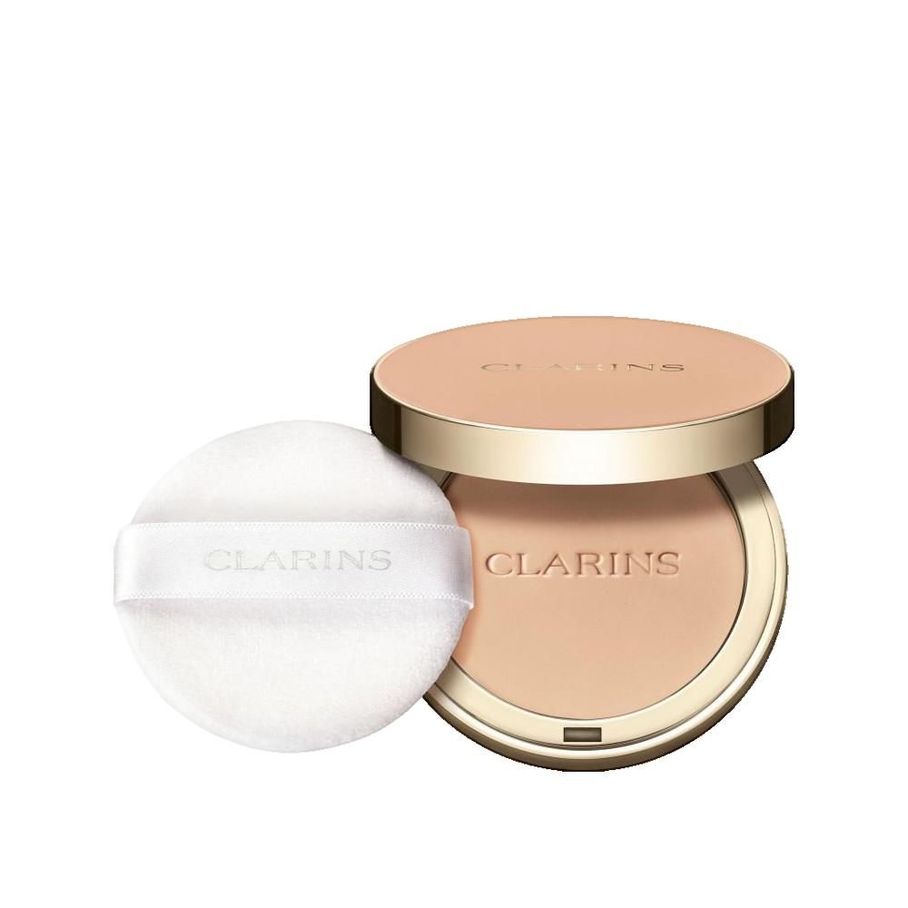 Compact poeder met spiegel en applicator. Gouden deksel met opschrift. Poeder in lichte tint. Applicator met band en opschrift.