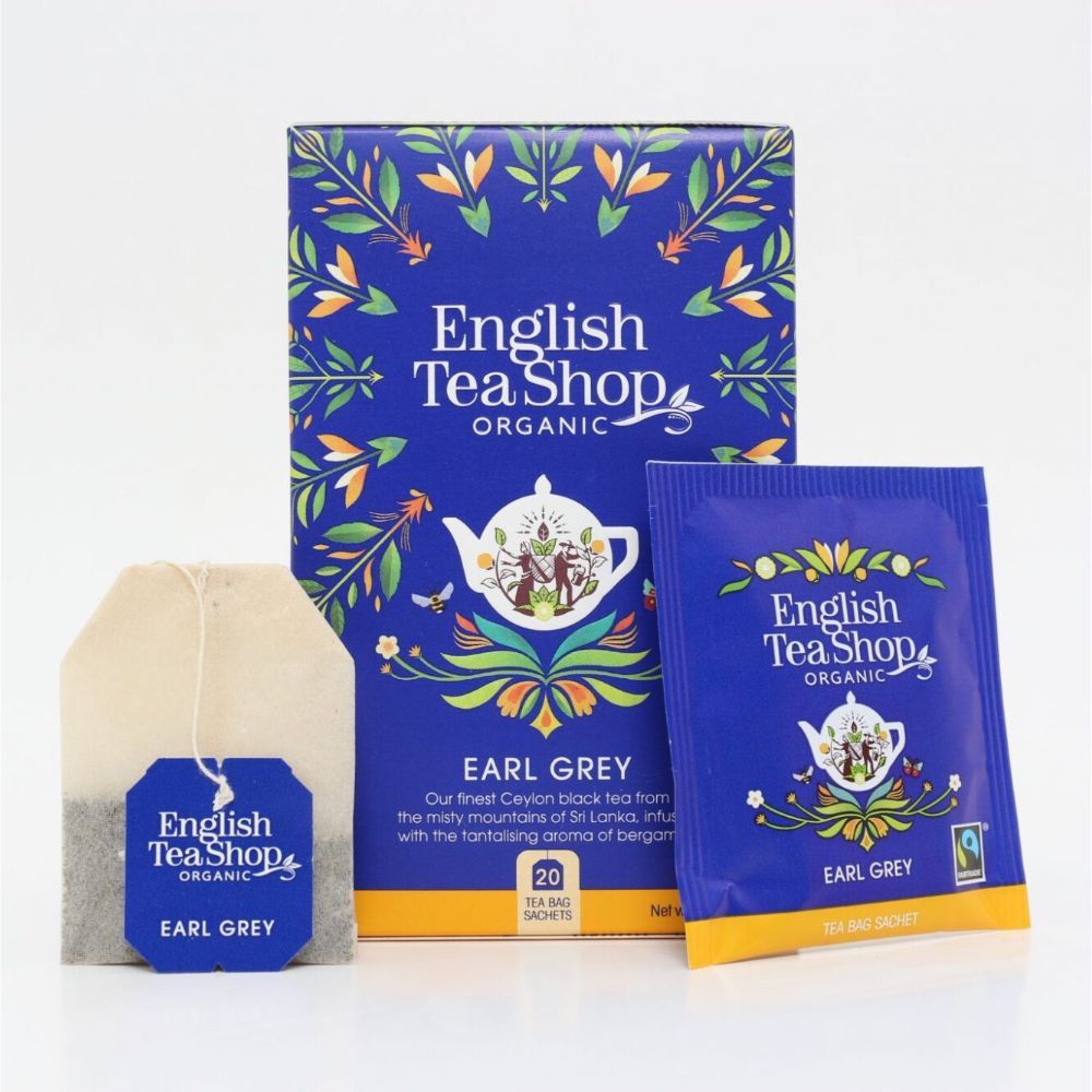 Blauwe doos, theezakje en individuele theezakjes. Opschrift: English Tea Shop, Earl Grey, Organic. Fairtrade-label.