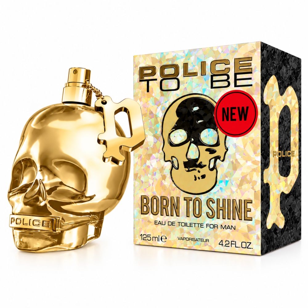 Flacon de parfum doré en forme de tête de mort avec sa boîte. Inscription "Born to Shine".