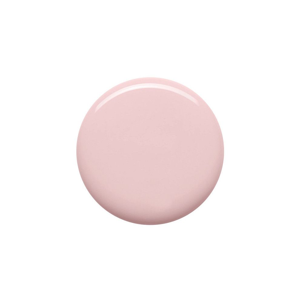 Tache circulaire de vernis à ongles rose sur fond blanc.