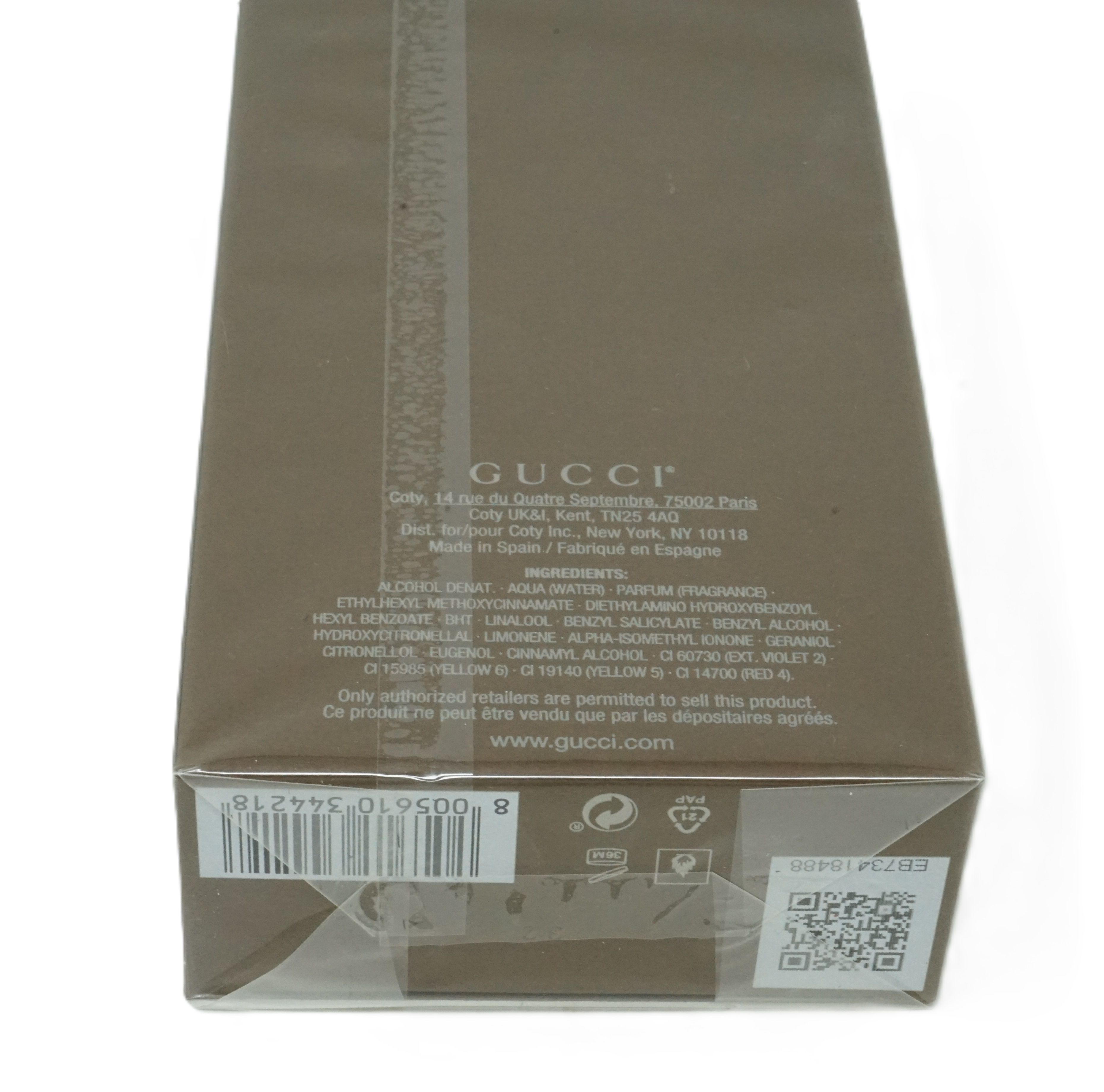 Gucci Guilty Absolute Pour Homme Eau De Parfum verpakking. Bruin, tekst en barcode. Fabrikantinfo en QR-code.