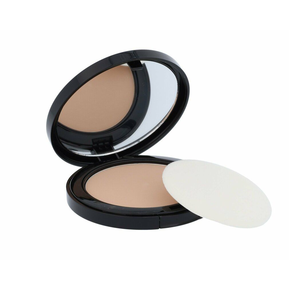Boîtier noir ouvert de poudre compacte avec miroir et poudre beige clair. Un applicateur blanc est à côté.