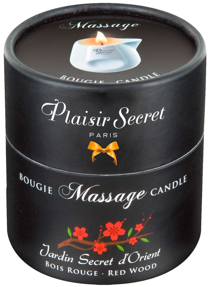 Emballage cylindrique noir. Inscriptions: Plaisir Secret, Bougie Massage, Jardin Secret d'Orient. Décor floral et logo de bougie.