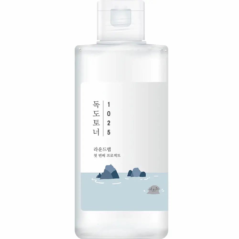 Flacon transparent avec étiquette blanche. Flacon avec bouchon blanc. Fond blanc clair.