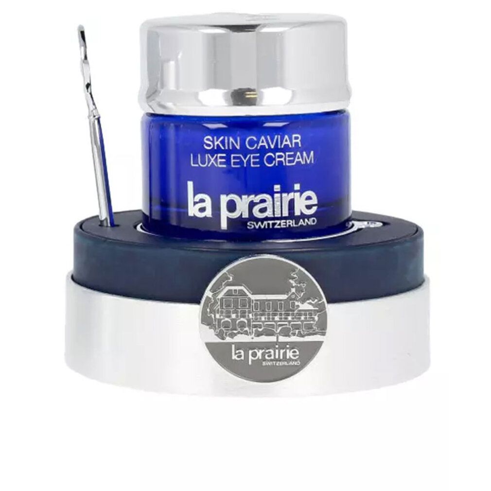 Blauwe pot met zilveren deksel, spatel en voet. Opschrift: Skin Caviar Luxe Eye Cream, La Prairie, Switzerland.