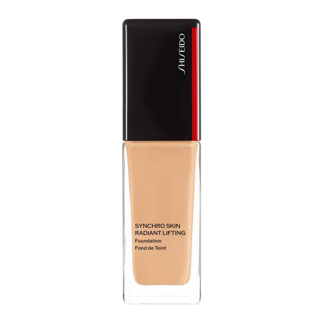 Flacon en verre contenant du fond de teint beige avec bouchon noir. Inscription: Synchro Skin Radiant Lifting Foundation. Marque: Shiseido.