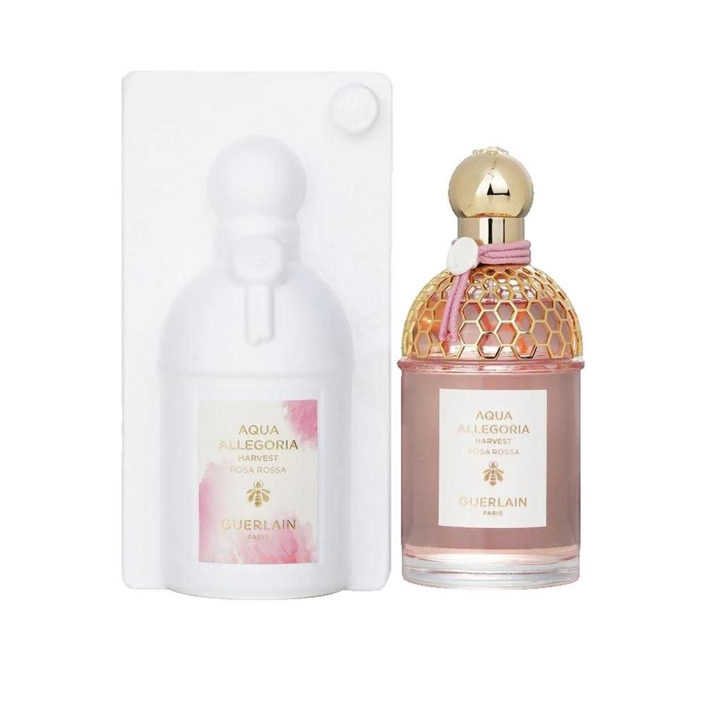 Parfumfles en verpakking. Fles met gouden dop, roze vloeistof, roze lint. Verpakking van wit plastic.