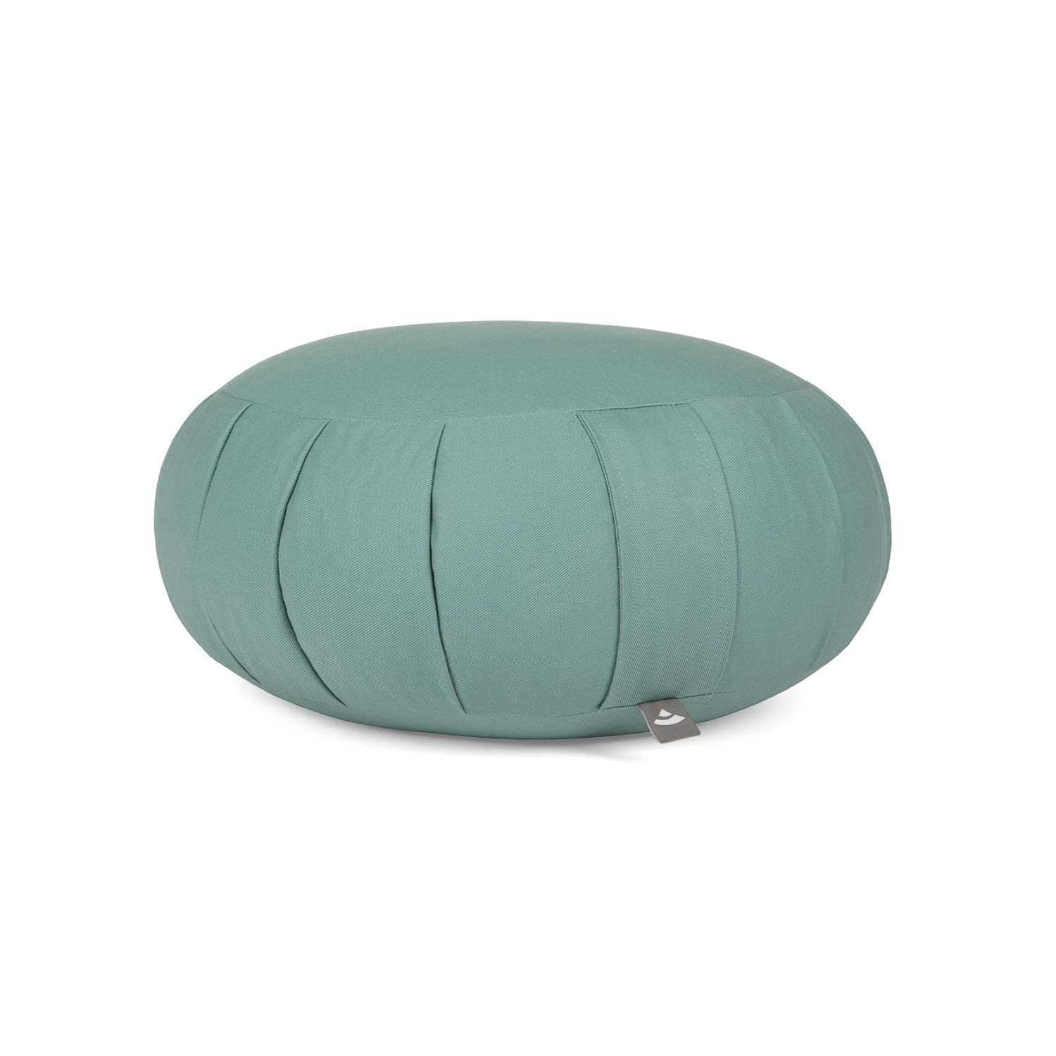 Coussin de méditation rond vert menthe, plis et petite étiquette.