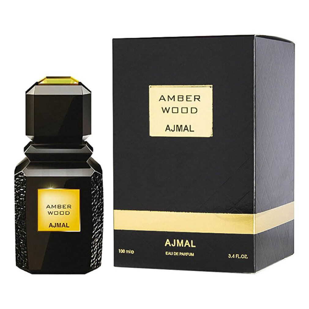 Flacon et boîte noirs. Flacon avec étiquette dorée AMBER WOOD et AJMAL. Boîte avec texte.