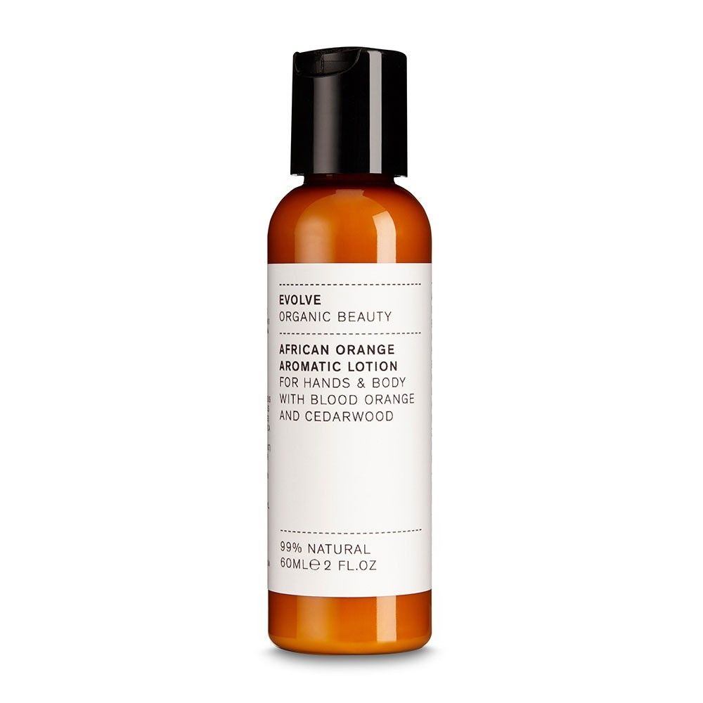 Flacon de lotion aromatique Evolve African Orange. Liquide orange dans un flacon avec bouchon noir. Inscription : African Orange Aromatic Lotion.