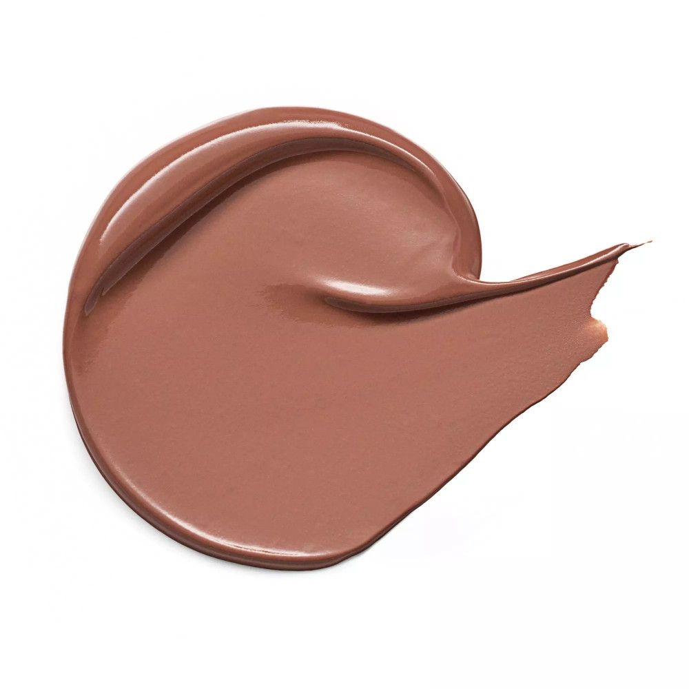 Échantillon de correcteur brun étalé sur fond blanc. La texture est mate.