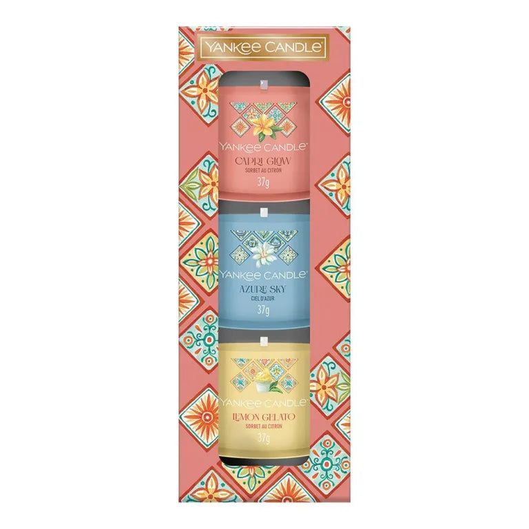 Coffret cadeau Yankee Candle avec trois bougies votives. Emballage rose à motifs floraux. Bougies visibles.