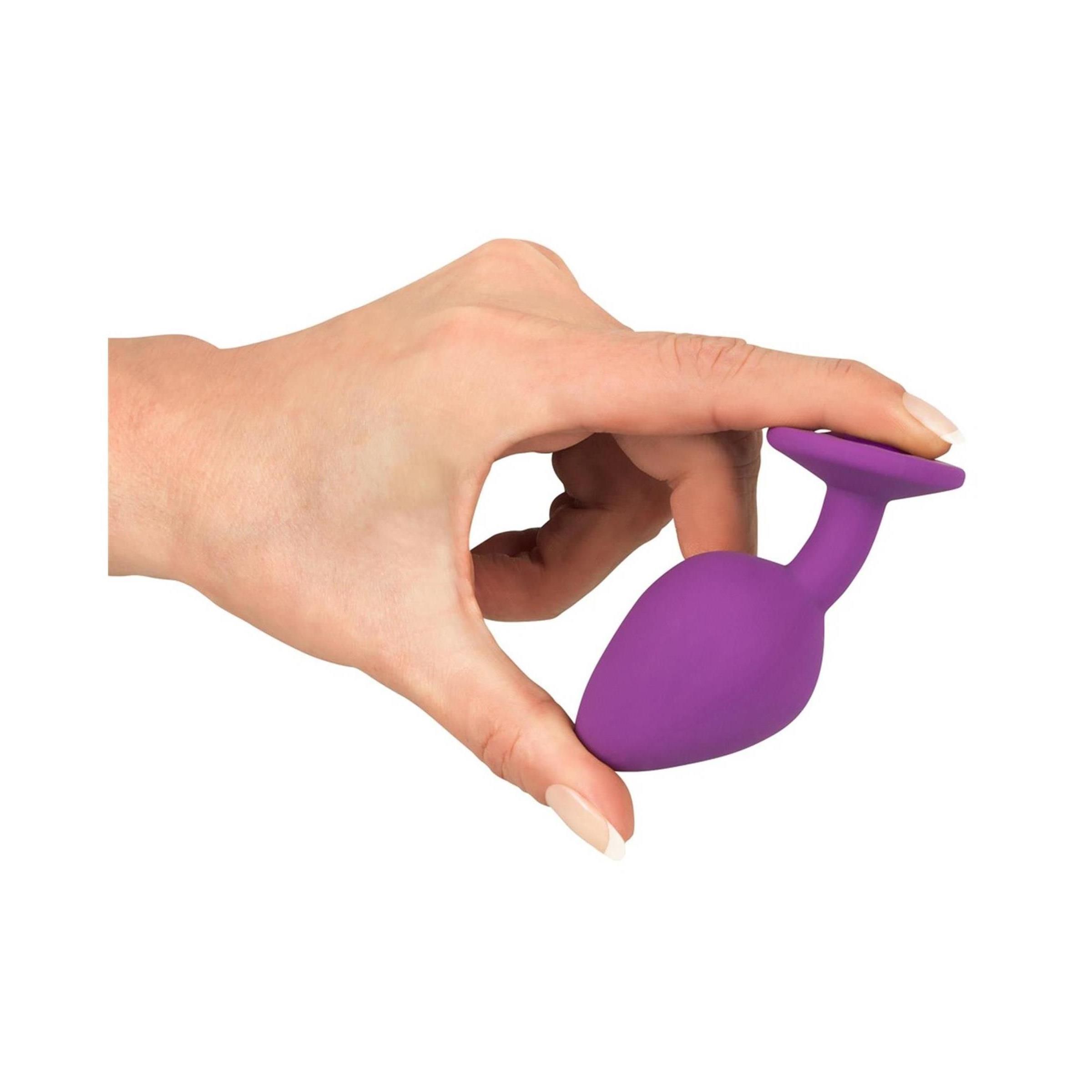 Plug anal violet avec bijou, vu de dessus.