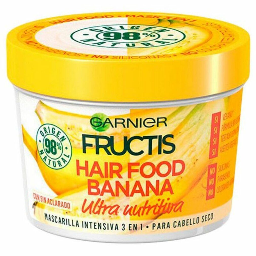 Pot jaune Garnier Fructis Hair Food Banane. Inscription: Ultra nutritiva. Illustrations de bananes. Logo 98% Natural.