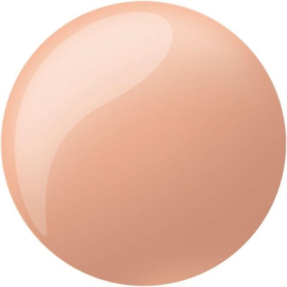 Tache ronde et brillante de vernis à ongles beige clair. La surface réfléchit la lumière.