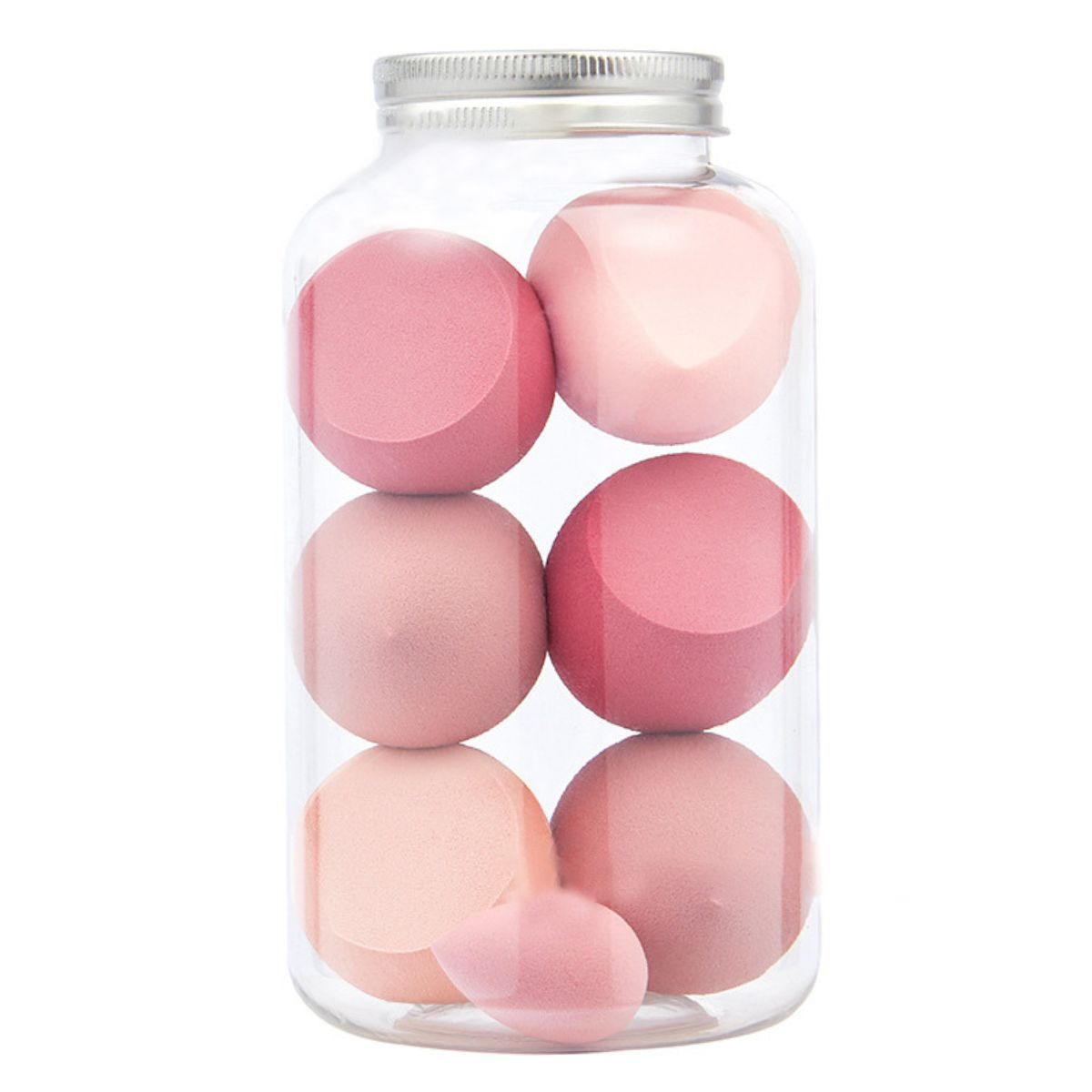Make-upsponzen in een transparante pot met zilveren deksel. Verschillende roze tinten en vormen.