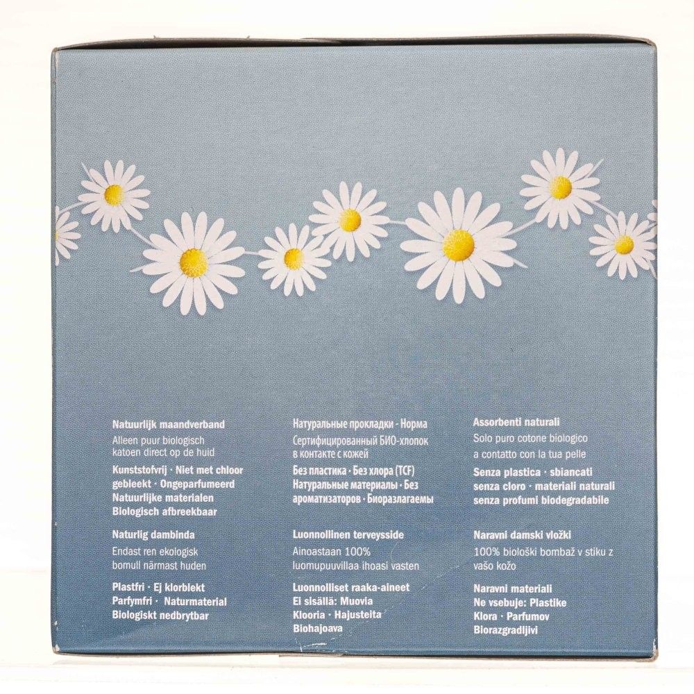 Emballage avec motif marguerites, texte multilingue.