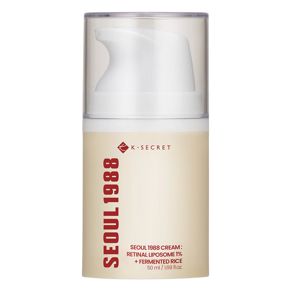 Crème K-Secret Seoul 1988 dans un flacon pompe, à côté d'épis et de grains de riz.