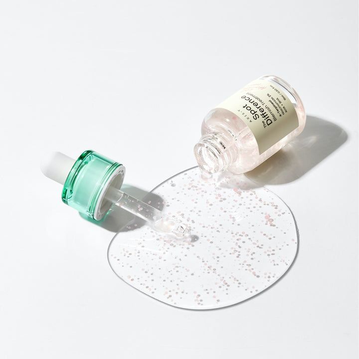 Transparante fles met groene dop en pipet. Vloeistof wordt op een oppervlak gegoten. Productnaam zichtbaar.