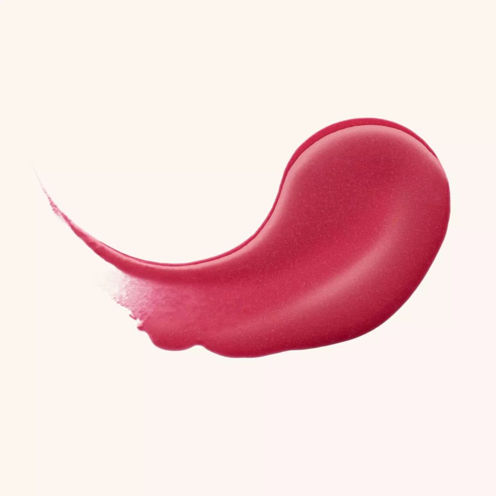 Échantillon de baume à lèvres rose. Texture brillante. Sur fond clair.